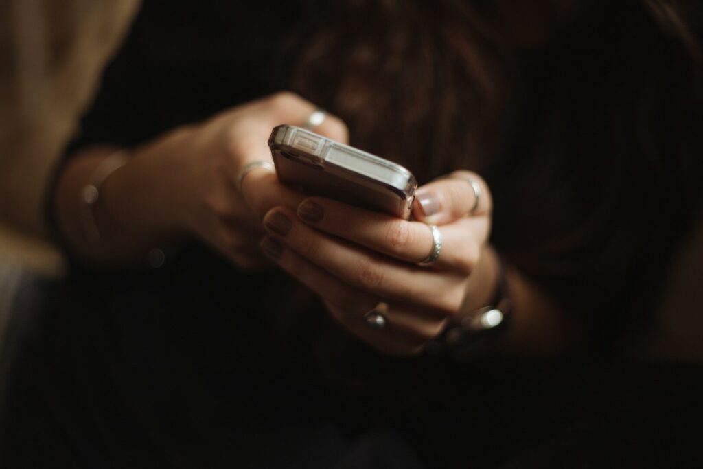 Person chatting with an AI assistant on a smartphone