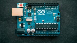 Arduino Uno board with DC motor and driver module on a workbench