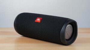 Black portable Bluetooth speaker on a wooden table